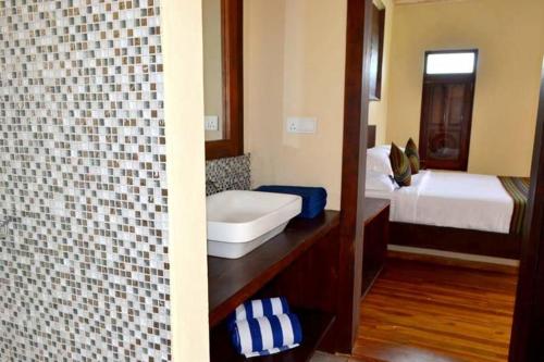 a bathroom with a sink and a tub in a room at Guru Beach Resort in Tangalle