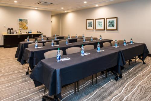 a conference room with tables and chairs with water bottles on them at Staybridge Suites - Pecos by IHG in Pecos