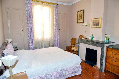 une chambre avec un lit et une cheminée dans l'établissement Appartement Cannes, à Cannes