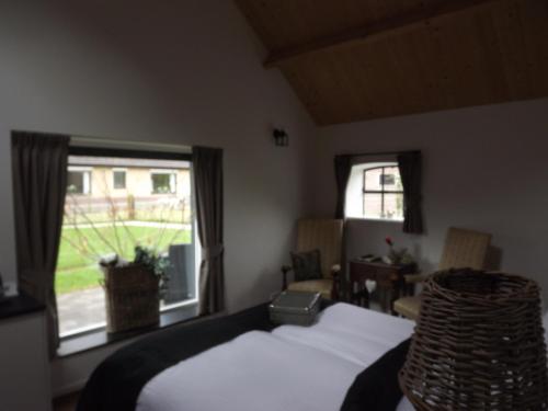 a bedroom with a bed and a window at B&B De Willemshoeve in Wageningen