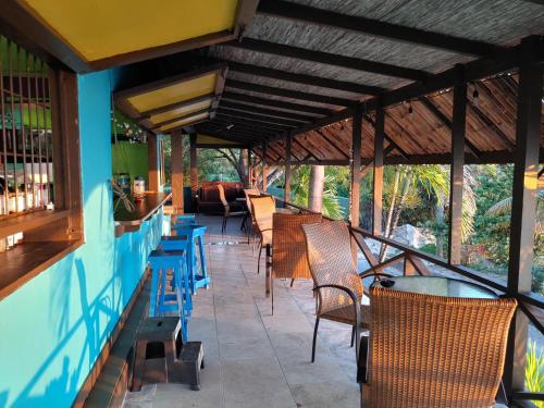 a row of chairs and tables on a patio at Orrie's Beach Bar and Hotel in Crab Hill