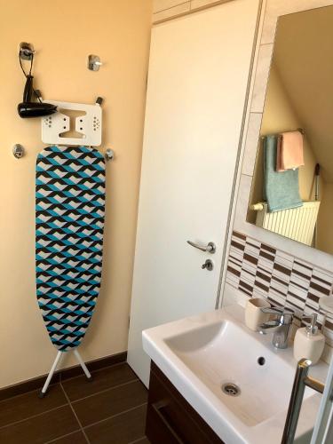 a bathroom with a sink and a mirror at Savelij apartament in Hévíz