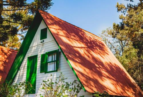 a house with a red roof with a window at Pousada São Chico Eco Village in São Francisco de Paula