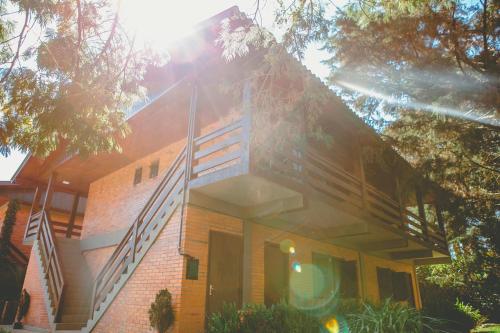 a brick house with stairs on the side of it at Pousada São Chico Eco Village in São Francisco de Paula