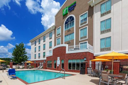 an image of a hotel with a pool at Holiday Inn Express Hotel and Suites Shreveport South Park Plaza by IHG in Shreveport
