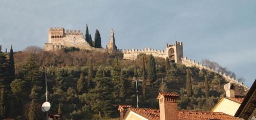 a castle on top of a hill with trees at GrappaLand in Crespano del Grappa