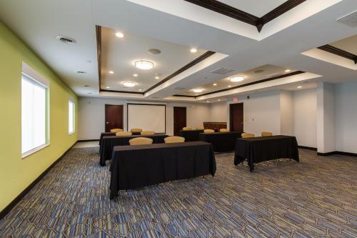 a conference room with tables and chairs and a whiteboard at Holiday Inn Express & Suites - South Bend - Notre Dame Univ. in South Bend