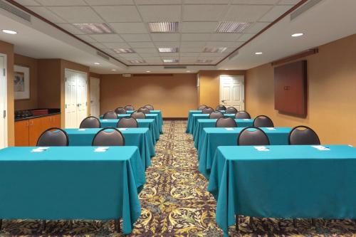 a conference room with blue tables and chairs at Staybridge Suites Rocklin - Roseville Area by IHG in Rocklin