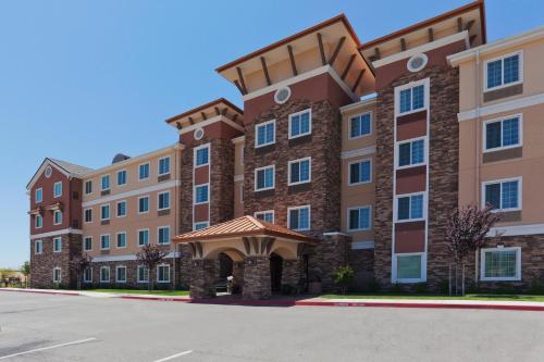 a large brick building with an arched entrance at Staybridge Suites Rocklin - Roseville Area by IHG in Rocklin