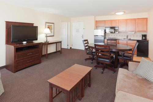 a living room with a kitchen and a dining room at Staybridge Suites Rocklin - Roseville Area by IHG in Rocklin