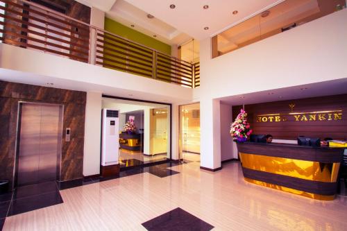 a lobby of a hotel with a front desk at Hotel Yankin in Yangon