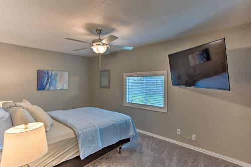 a bedroom with a bed with a ceiling fan and a window at Walk to ATandT Stadium Arlington Home with Yard! in Arlington