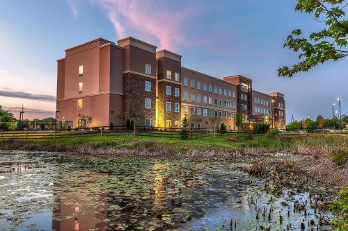 a large building with a pond in front of it at Staybridge Suites Knoxville West by IHG in Knoxville