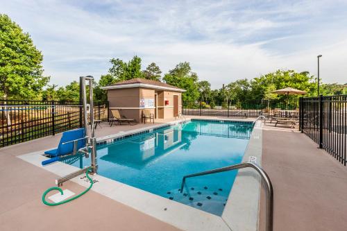 a swimming pool with a gazebo next to a fence at Staybridge Suites Knoxville West, an IHG Hotel in Knoxville