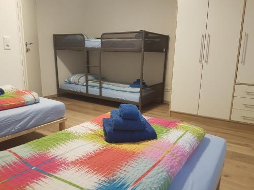 a room with two bunk beds and a colorful blanket at Casa Colori Rheinfelden in Herten