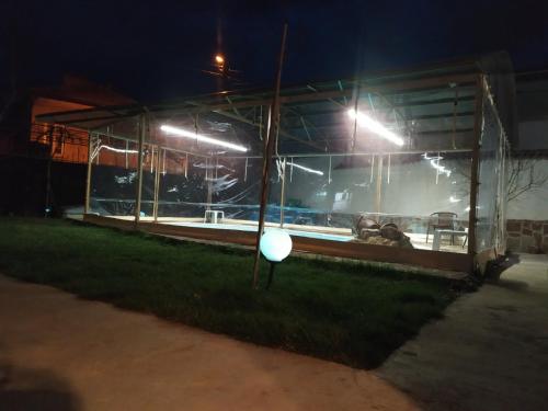 a building with a frisbee in the grass at night at Къща за гости с минерална вода "Терма Асклепий" in Kyustendil