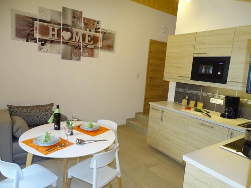 a kitchen and dining room with a white table and chairs at Ferienwohnungen Eva in Mühlbach am Hochkönig
