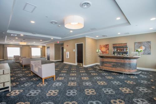 a lobby of a hotel with a fireplace at Voco The Clair Cincinnati Downtown by IHG in Cincinnati