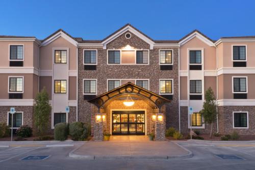 a large brick building with a clock on the front of it at Staybridge Suites Tucson Airport, an IHG Hotel in Tucson