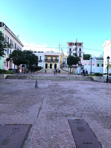 an empty street in a city with buildings at Navona Studios in San Juan