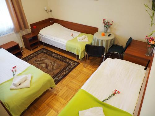 a room with two beds and a table and chairs at Dom Gościnny 8 km od Suntago, Deepspot in Radziejowice