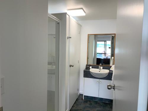 a bathroom with a sink and a mirror at Wanaka Heights Motel in Wanaka