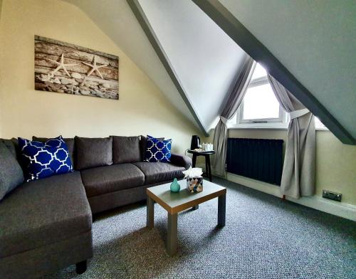 a living room with a couch and a table at The Hedley Townhouse in Bournemouth
