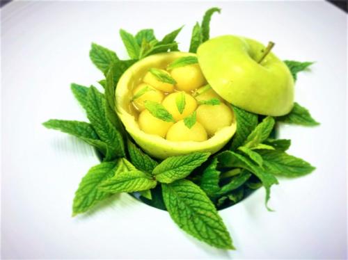 a close up of an apple and some green leaves at Botaniq Hotel Boutique in Mojácar