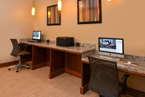 an office with two desks with a computer and a printer at Staybridge Suites Merrillville by IHG in Merrillville