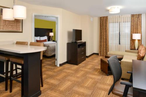 a hotel suite with a living room and a bedroom at Staybridge Suites Merrillville by IHG in Merrillville