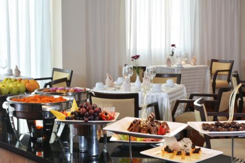 a dining room with a table filled with food at Crowne Plaza Monterrey Aeropuerto by IHG in Monterrey