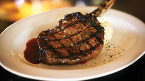a piece of steak on a plate with ice cream at Crowne Plaza Shenandoah - The Woodlands Area by IHG in The Woodlands