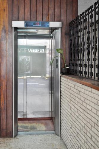 an open door to a utility entrance with a potted plant at Hotel María Teresa in Salamanca