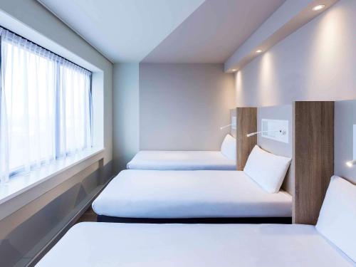 Säng eller sängar i ett rum på ibis budget Amsterdam City South