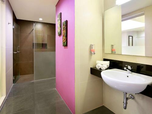 a bathroom with a sink and a shower at Primera Hotel Seminyak in Seminyak