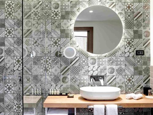 a bathroom with a sink and a mirror at Tarcin Forest Resort & Spa Sarajevo - MGallery Collection in Tarčin