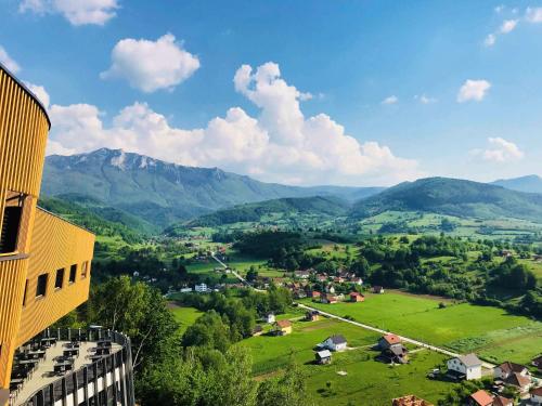 a view of a village in a valley with mountains at Tarcin Forest Resort & Spa Sarajevo - MGallery Collection in Tarčin