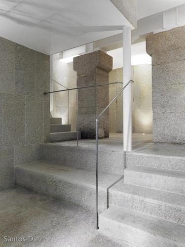 a lobby with stairs in a building with a pillar at Hotel Pazo de Altamira in Santiago de Compostela