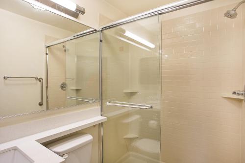a bathroom with a shower stall and a toilet at Candlewood Suites Oak Grove/Fort Campbell, an IHG Hotel in Oak Grove