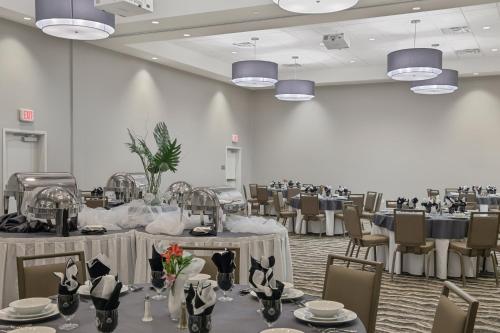a banquet hall with tables and chairs and tablesearcher at Staybridge Suites - Florence Center by IHG in Florence