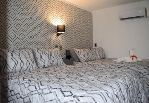 a bedroom with a large bed and a lamp at El Suburbio - Morelos Sur in Morelia
