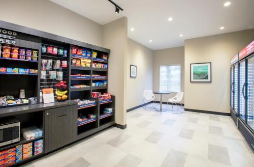 a pharmacy aisle with a counter and shelves of food at Candlewood Suites - Miami Exec Airport - Kendall by IHG in Kendall