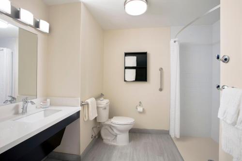 a bathroom with a toilet and a sink and a shower at Candlewood Suites - Miami Exec Airport - Kendall by IHG in Kendall
