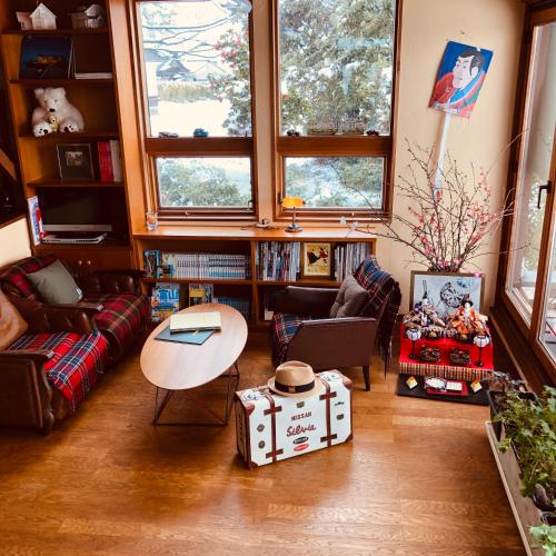 a living room with a couch and a table at ガーデンハウス Mako Land in Toyama