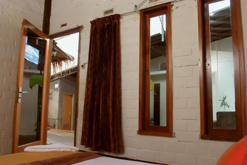 a room with windows and a curtain on a wall at Bantal Guling Villa in Lembang