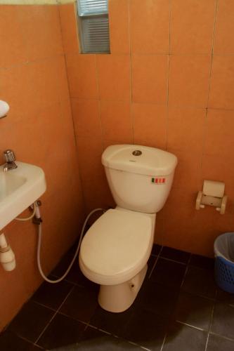 a bathroom with a toilet and a sink at Bantal Guling Villa in Lembang