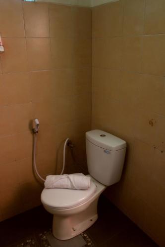 a bathroom with a white toilet in a room at Bantal Guling Villa in Lembang