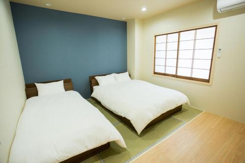 Giường trong phòng chung tại Hasunoha