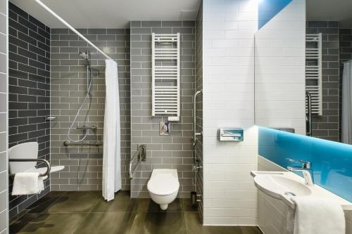 a bathroom with a toilet and a sink at Holiday Inn Express - Rzeszow Airport by IHG in Rzeszów