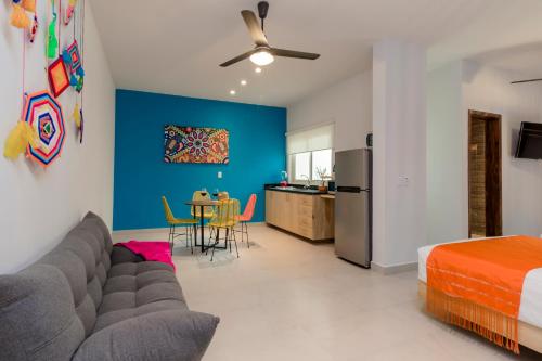 a living room with a couch and a blue wall at Riviera Sayulita Hotel in Sayulita